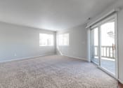 Thumbnail 4 of 42 - A spacious room with carpeted floor and sliding glass doors. at Saylorville Lakeside, Polk City, IA, 50226