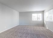 Thumbnail 1 of 42 - A spacious room with carpeted floor and two windows. at Saylorville Lakeside, Polk City, Iowa