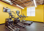 Thumbnail 19 of 25 - A row of treadmills are lined up in a gym at Spaulding Lofts Apartments, Grinnell, Iowa