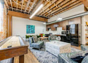 Thumbnail 10 of 25 - A room with a pool table and a couch at Spaulding Lofts Apartments, Grinnell