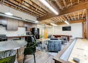 Thumbnail 13 of 25 - A room with a pool table and a bar area at Spaulding Lofts Apartments, Grinnell, IA