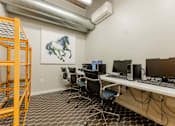 Thumbnail 23 of 25 - A room with a desk, chairs, and a painting of a horse at Spaulding Lofts Apartments, Grinnell, IA