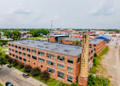 Thumbnail 25 of 25 - An aerial view of a large brick building with the word at Spaulding Lofts Apartments, Iowa, 50112