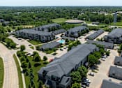 Thumbnail 52 of 57 - A large apartment complex with a swimming pool.