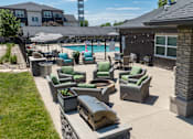 Thumbnail 55 of 57 - A backyard with a pool and patio furniture.