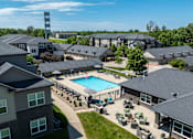 Thumbnail 58 of 60 - A large building complex with a pool in the middle.
