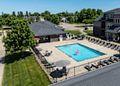 Thumbnail 59 of 60 - A large swimming pool surrounded by lounge chairs and umbrellas.