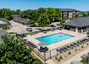 Thumbnail 28 of 57 - A swimming pool surrounded by a black fence and lounge chairs.