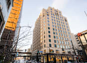 Thumbnail 48 of 50 - A tall building with a sign that says "Open" on the front.