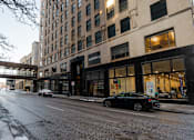 Thumbnail 47 of 50 - A black car is parked on the side of a street.