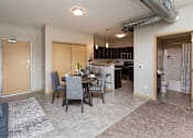 Thumbnail 13 of 31 - an open living room and kitchen with a dining room table and chairs at Lake Shore Apartments, Iowa, 50021