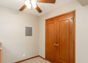 Thumbnail 3 of 13 - an empty bedroom with a closet and a ceiling fan at Lake Shore Place Apartments, Iowa
