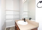 Thumbnail 24 of 56 - A bathroom with a sink and a mirror at Meadowlark Place Apartments, Georgia