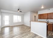 Thumbnail 49 of 56 - A kitchen with a white counter and wooden cabinets at Meadowlark Place Apartments, Georgia