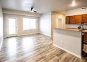 Thumbnail 34 of 56 - A room with a kitchen area and a ceiling fan at Meadowlark Place Apartments, Iowa, 50111