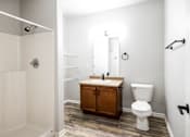 Thumbnail 53 of 56 - A bathroom with a toilet, sink, and shower at Meadowlark Place Apartments, Grimes, IA,  50111