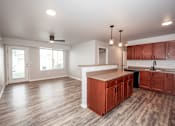 Thumbnail 21 of 56 - A kitchen with wooden cabinets and a countertop at Meadowlark Place Apartments, IA, 50111