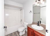 Thumbnail 18 of 56 - A white toilet sits next to a sink in a bathroom at Meadowlark Place Apartments, Iowa, 50111