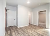 Thumbnail 14 of 56 - A room with a white door and a brown floor at Meadowlark Place Apartments, Georgia