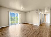Thumbnail 2 of 47 - A room with wooden flooring and sliding glass doors at Melbourne Apartments in Des Moines, Iowa 50320.