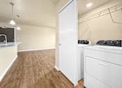 Thumbnail 5 of 47 - A laundry room with a washer and dryer at Melbourne Apartments in Des Moines, Iowa 50320.