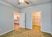 Thumbnail 5 of 12 - A room with a ceiling fan and two doors.