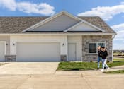 Thumbnail 65 of 69 - two people walking in front of a house at Converge NW, Waukee  