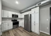 Thumbnail 31 of 69 - a kitchen with white cabinets and stainless steel appliances at Converge NW, Waukee, IA 50263  