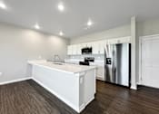 Thumbnail 23 of 69 - a kitchen with a white counter top and a stainless steel refrigerator at Converge NW, Waukee Iowa  