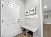 Thumbnail 11 of 69 - a white closet with a white door and a white bench at Converge NW, Iowa, 50263