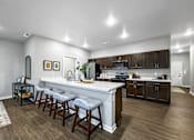 Thumbnail 15 of 69 - a kitchen with a large counter top in a house at Converge NW, Waukee  