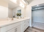 Thumbnail 48 of 69 - A bathroom with a white counter and a large mirror.at Converge NW, Waukee Iowa  