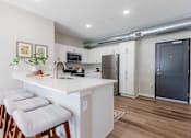 Thumbnail 3 of 69 - A kitchen with white cabinets and a white island with three stools at Converge NW, Waukee, 50263