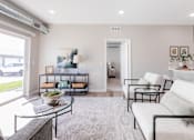 Thumbnail 33 of 69 - A living room with a glass coffee table and a white sofa.at Converge NW, Waukee  