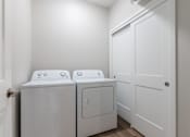 Thumbnail 43 of 69 - Two white front loading washing machines in a laundry room.at Converge NW, Iowa  