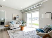 Thumbnail 10 of 69 - A living room with a white couch, a wooden coffee table, and a large window.at Converge NW, Iowa  