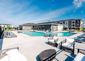 Thumbnail 64 of 69 - A large outdoor swimming pool area with lounge chairs and a building in the background.at Converge NW, Waukee, IA 50263  