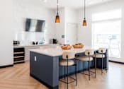 Thumbnail 58 of 69 - a kitchen with a large island and white and blue cabinets at Converge NW, Waukee, IA 50263  