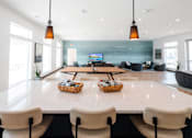 Thumbnail 59 of 69 - a large dining room with tables and chairs and a television in the background at Converge NW, Waukee, 50263  