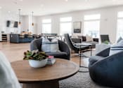 Thumbnail 57 of 69 - a living room with couches and chairs and a table with a plant at Converge NW, Waukee  