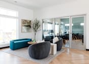 Thumbnail 56 of 69 - a living room with blue and black furniture and glass doors at Converge NW, Iowa, 50263