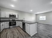 Thumbnail 3 of 42 - the kitchen of a home with white cabinets and stainless steel appliances at Forge65, Pleasant Hill, Iowa
