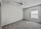 Thumbnail 15 of 42 - an empty room with a ceiling fan and a window at Forge65, Iowa, 50327