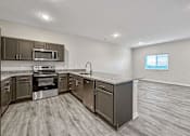 Thumbnail 6 of 42 - the kitchen has stainless steel appliances and granite counter tops at Forge65, Iowa, 50327