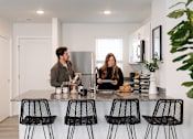 Thumbnail 8 of 42 - a man and a woman standing at a kitchen counter at Forge65, Pleasant Hill, IA, 50327