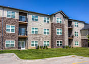 Thumbnail 39 of 50 - an exterior view of an apartment building with green grass at Stonegate Crossing Apartments, Clive, IOWA