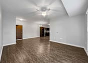 Thumbnail 19 of 50 - A spacious room with wood flooring and a ceiling fan. at Stonegate Crossing Apartments, Clive, 50325