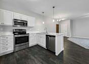 Thumbnail 2 of 50 - an empty kitchen with white cabinets and stainless steel appliances at Stonegate Crossing Apartments, IOWA, 50325