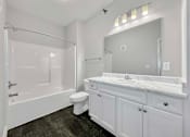 Thumbnail 8 of 50 - A white bathroom with a toilet, sink, and shower at Stonegate Crossing Apartments, Clive, IA, 50325