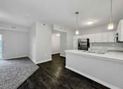 Thumbnail 4 of 50 - A kitchen with white cabinets and a stainless steel refrigerator at Stonegate Crossing Apartments, Clive, IOWA